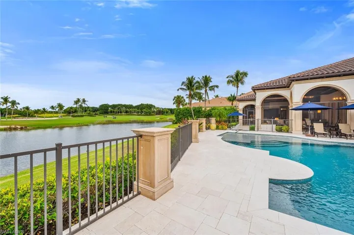 View of swimming pool featuring a water view and a patio area