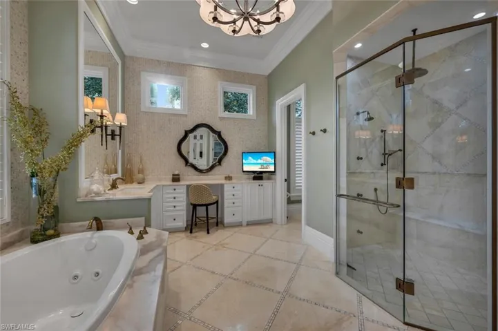Bathroom with vanity, a tub with jets, crown molding, a stall shower, and recessed lighting