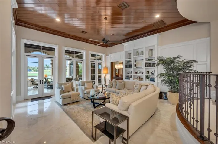 Living room with wooden ceiling, a water view, crown molding, french doors, and ceiling fan
