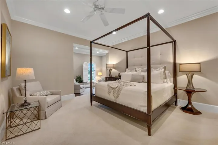 Carpeted bedroom with ceiling fan, ornamental molding, and recessed lighting