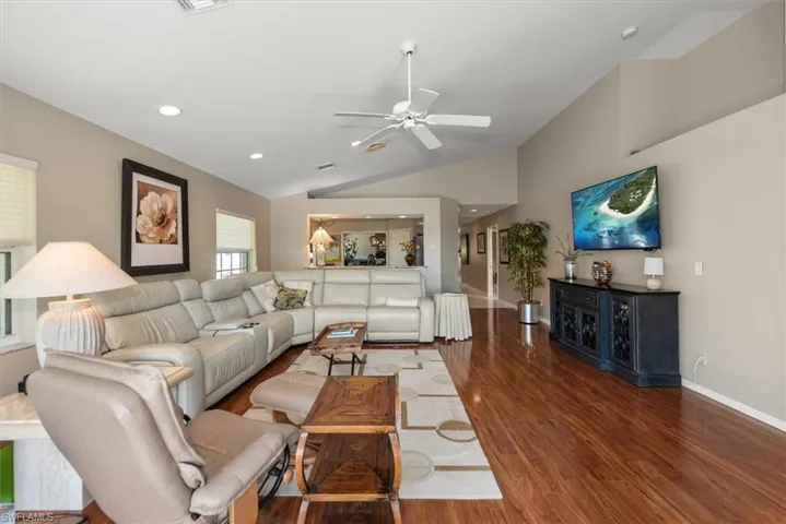 Spacious and bright living room with comfortable leather sectional / recliner sofas
