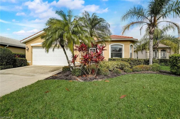 View of front of home with a front yard and a garage