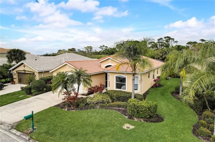 View of front of home featuring a garage and a front yard