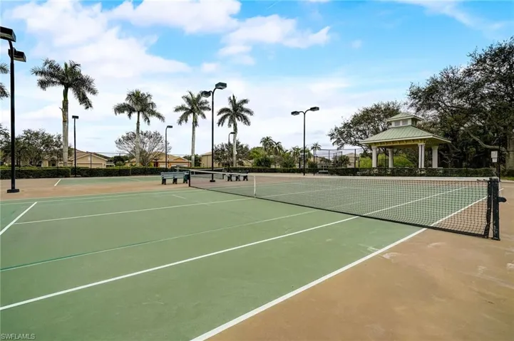 View of tennis court with a gazebo