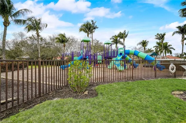 View of jungle gym featuring a lawn