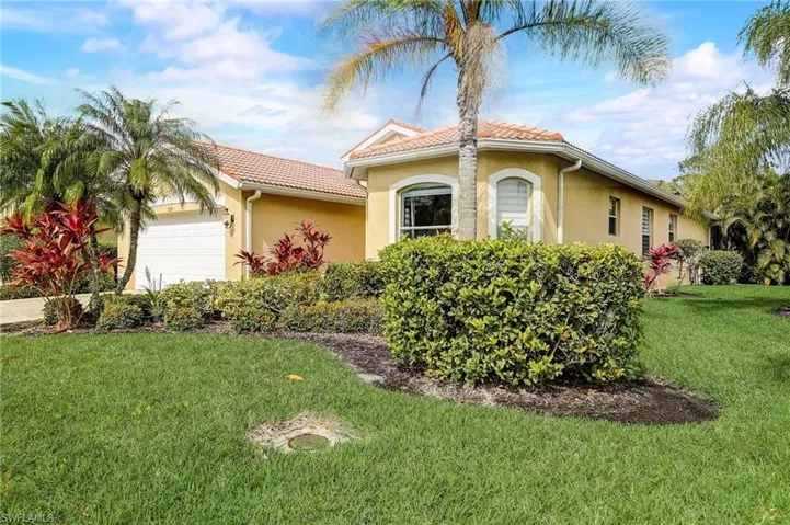 Mediterranean / spanish-style house featuring a front lawn and a garage