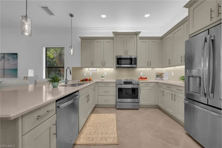 Spacious kitchen with quartz countertops, stainless steel appliances, and ample cabinetry.