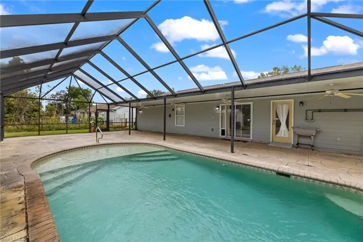 Pool with a patio, a lanai, and a ceiling fan