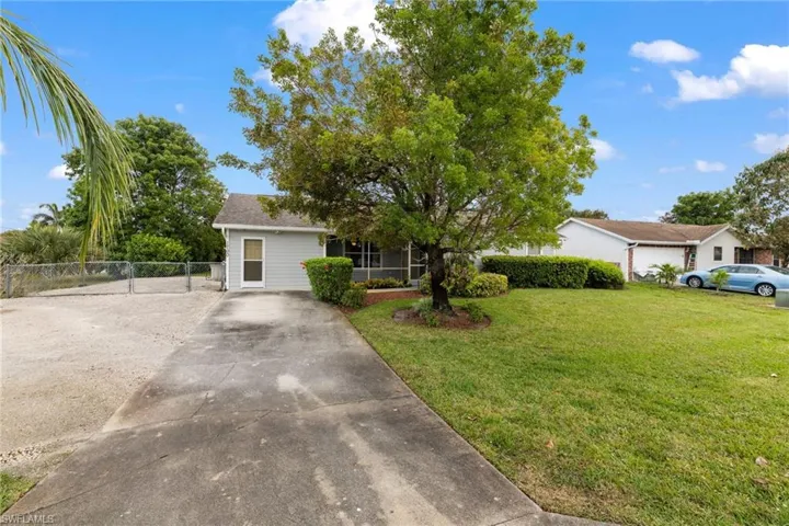 Ranch-style house featuring fence and a front yard