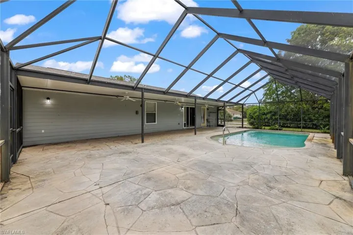 Outdoor pool with glass enclosure and a patio
