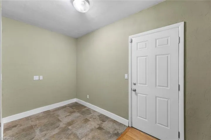 Empty room featuring baseboards