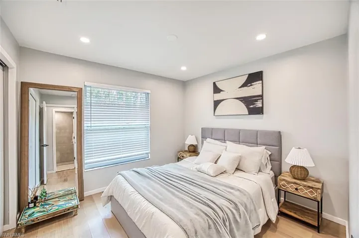 Bedroom with light wood-style floors and recessed lighting