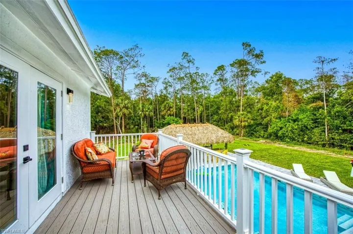 Wooden terrace with outdoor lounge area and a lawn