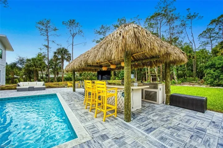 Outdoor pool with an outdoor hangout area and a patio