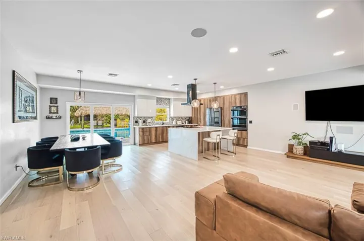 Living room featuring light wood-type flooring and recessed lighting