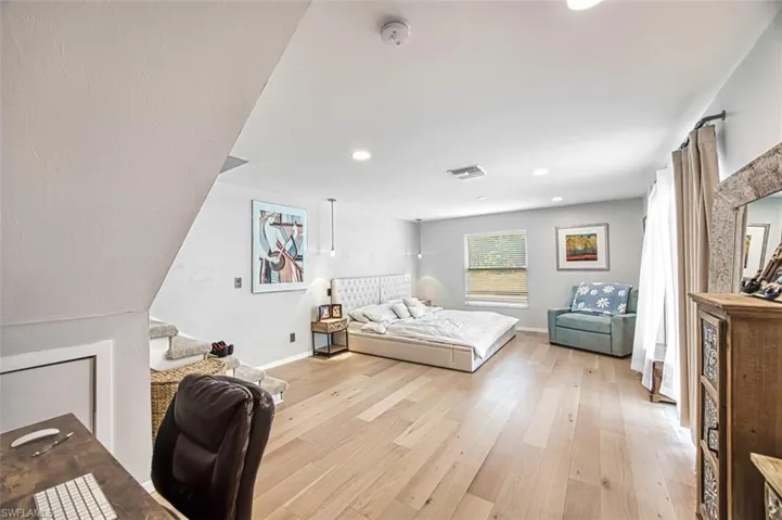 Bedroom with light wood-type flooring and recessed lighting