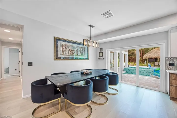 Dining space featuring french doors, light wood-style floors, and recessed lighting