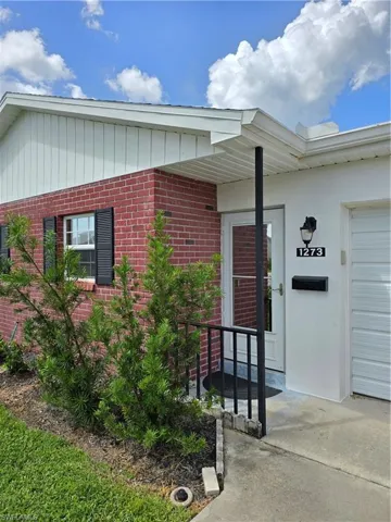 Doorway to property featuring a garage