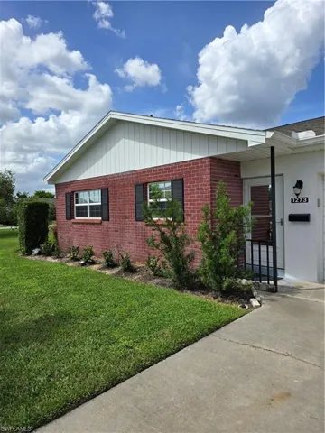 Single story home with a front yard