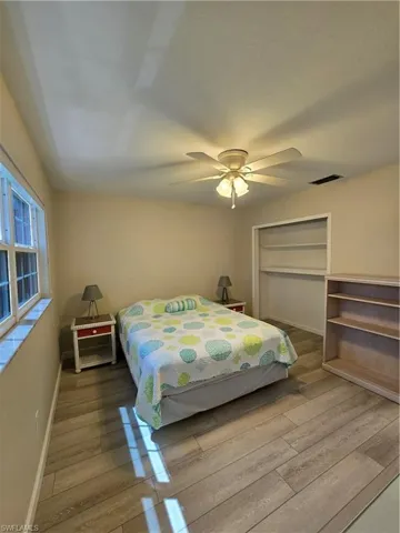 Bedroom with ceiling fan and wood-type flooring