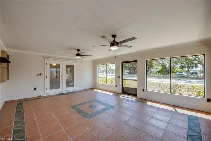 Unfurnished sunroom featuring french doors