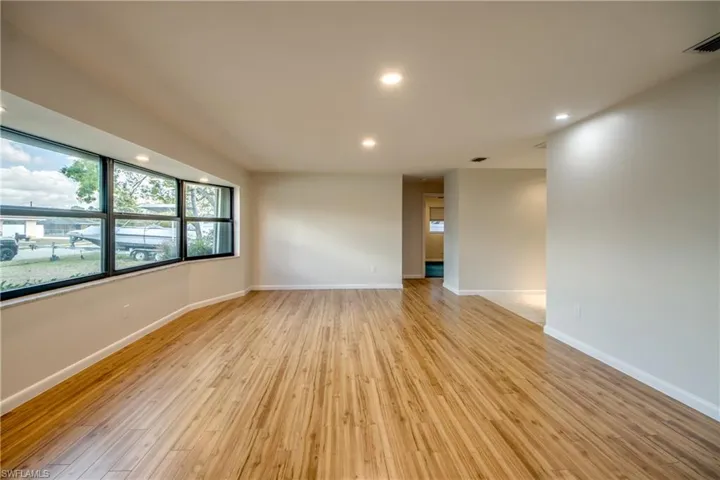 Empty room with recessed lighting and light wood-style floors