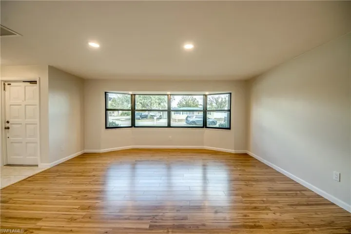 Spare room with light wood finished floors and recessed lighting