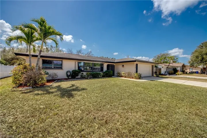 Ranch-style home with stucco siding, driveway, and an attached garage