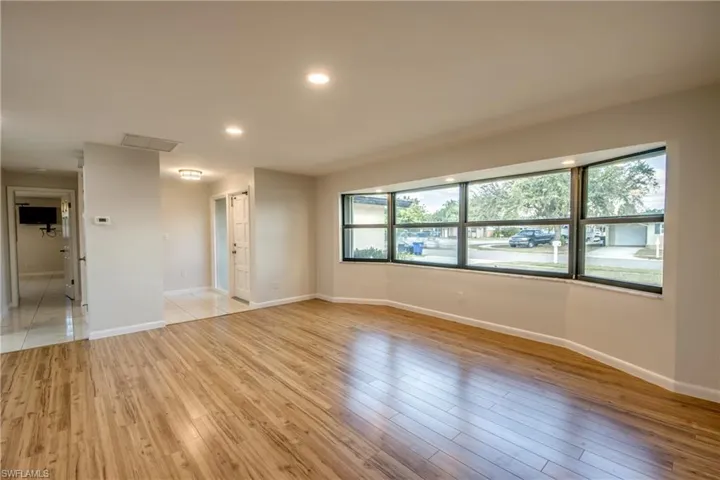 Empty room featuring light wood-style flooring and recessed lighting