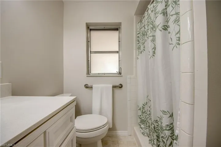 Full bathroom with vanity, a shower stall, and light tile patterned floors