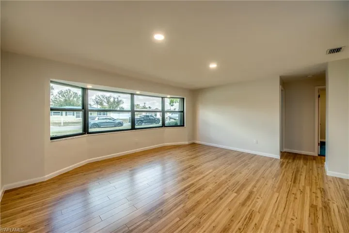 Spare room featuring light wood-type flooring and recessed lighting
