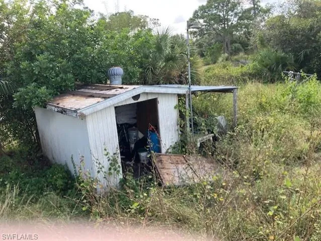 Entry to storm shelter with an outdoor structure