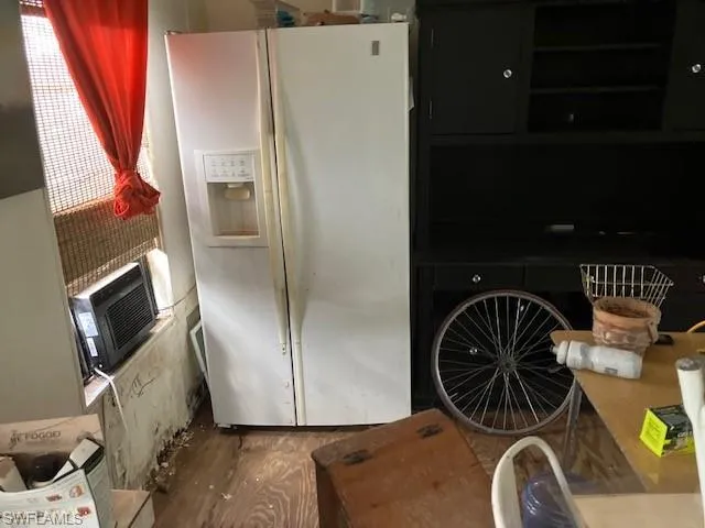 Kitchen with white refrigerator with ice dispenser