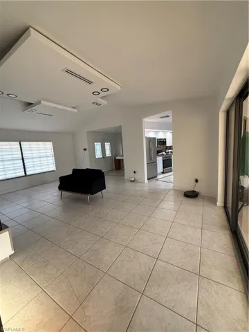 Living room with light tile patterned flooring