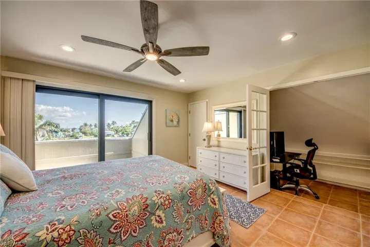 Bedroom featuring access to exterior, recessed lighting, french doors, and light tile patterned flooring