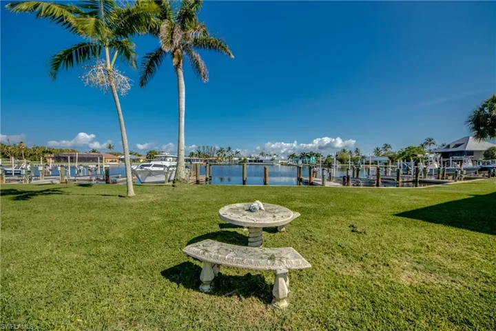 View of yard with a dock, a water view, and boat lift