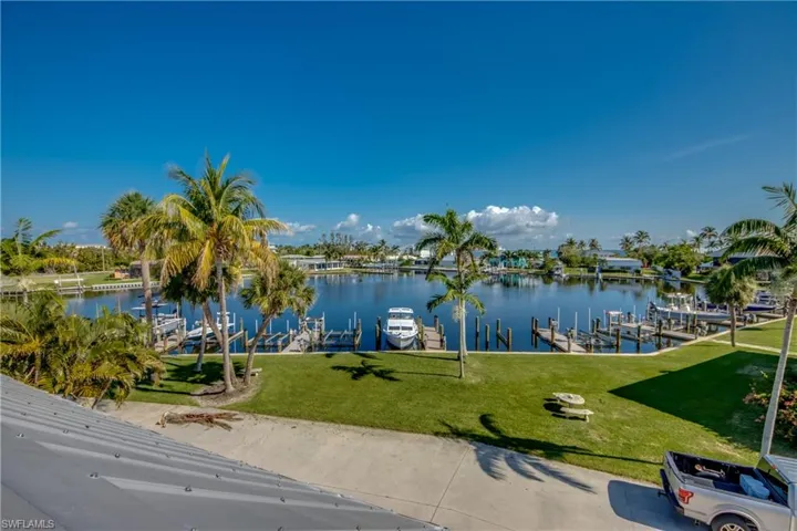 Property view of water with a dock and boat lift