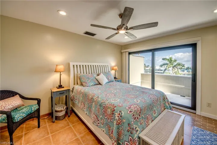 Tiled bedroom featuring access to outside, visible vents, baseboards, and recessed lighting