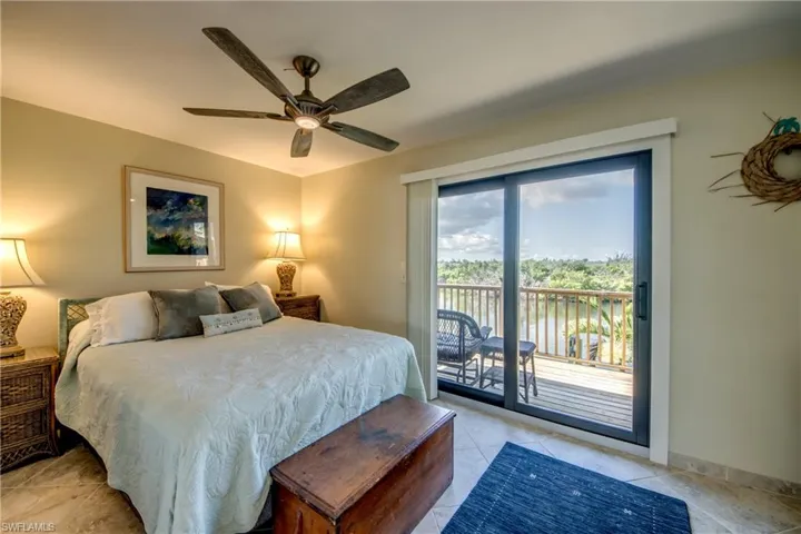 Bedroom featuring ceiling fan, access to outside, light tile patterned floors, and baseboards