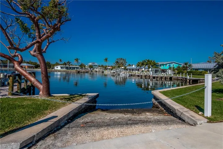Dock area featuring a water view and a yard