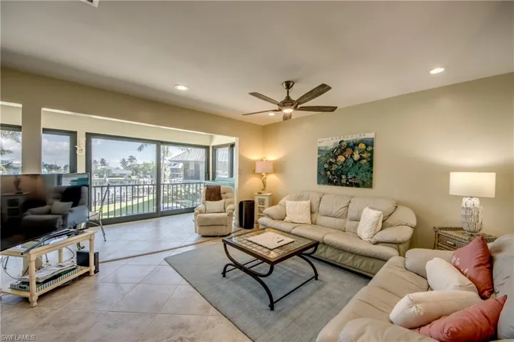 Living room featuring recessed lighting, ceiling fan, and light tile patterned floors