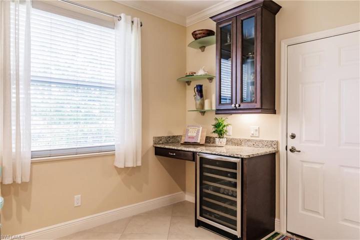 NEW WINE COOLER PLUS BAR & GLASS CABINET! THIS HOME LACKS NOTHING! IT IS EVEN MORE BEAUTIFUL IN PERSON!