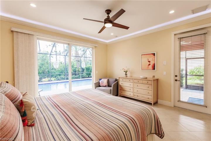 MASTER BEDROOM WITH DOOR TO THE LANAI FOR EASY ACCESS IN & OUT OF THE MASTER! NOTE THE CROWN MOLDING WITH LED LIGHTING ABOVE! AMAZING!