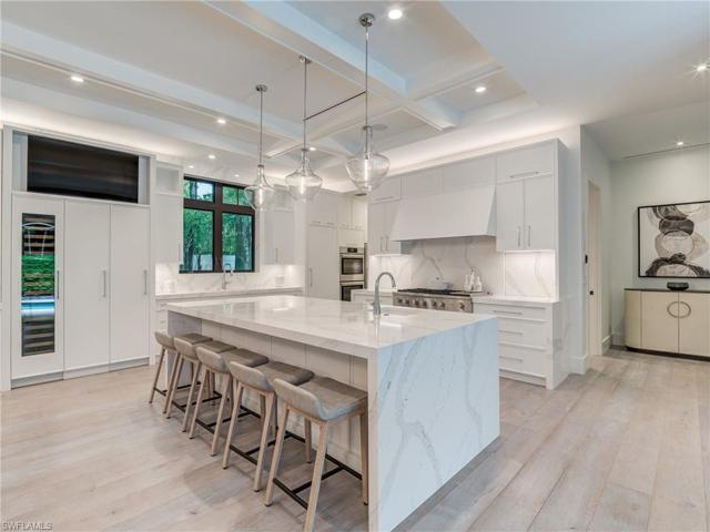 Sleek waterfall quartz counters and backsplash