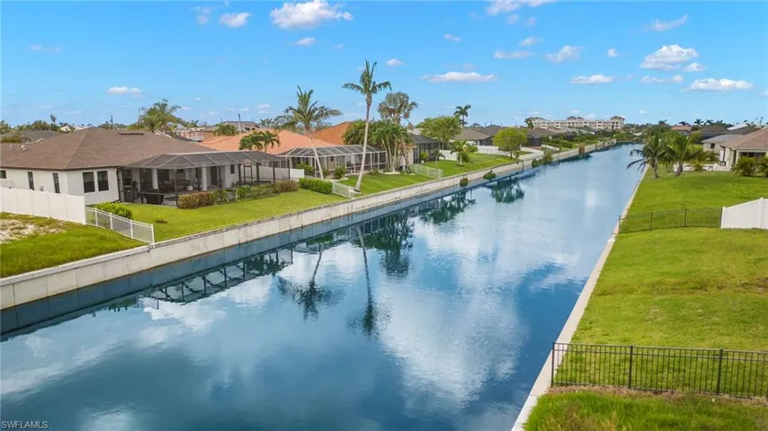 View of pool with a yard and a water view
