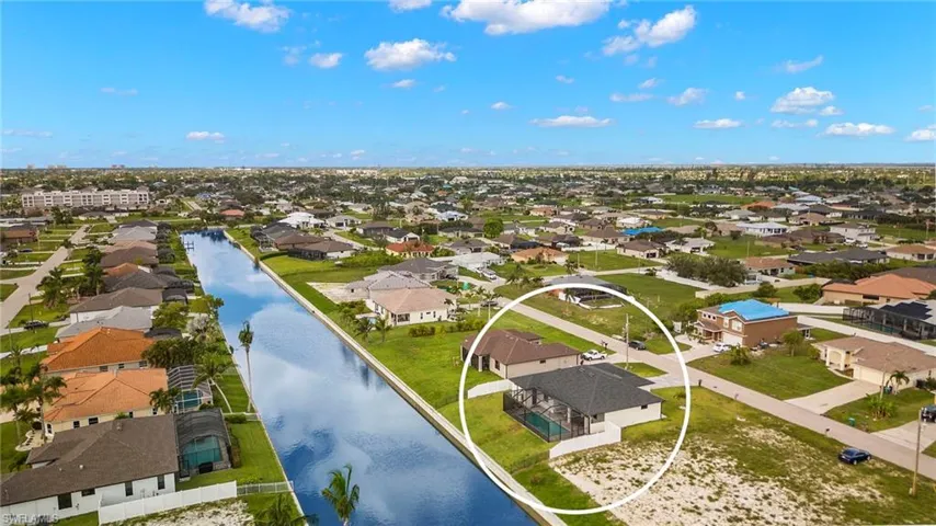 Birds eye view of property with a water view