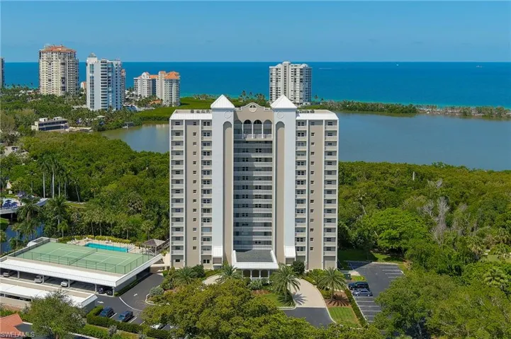 Birds eye view of property with a water view