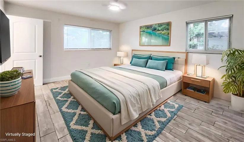 Bedroom with wood tiled floors and baseboards
