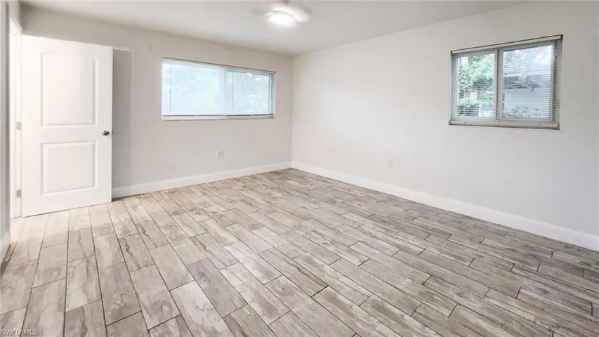 Spare room with wood finish floors and baseboards