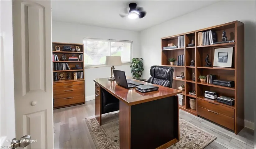 Office area with light wood-type flooring and baseboards